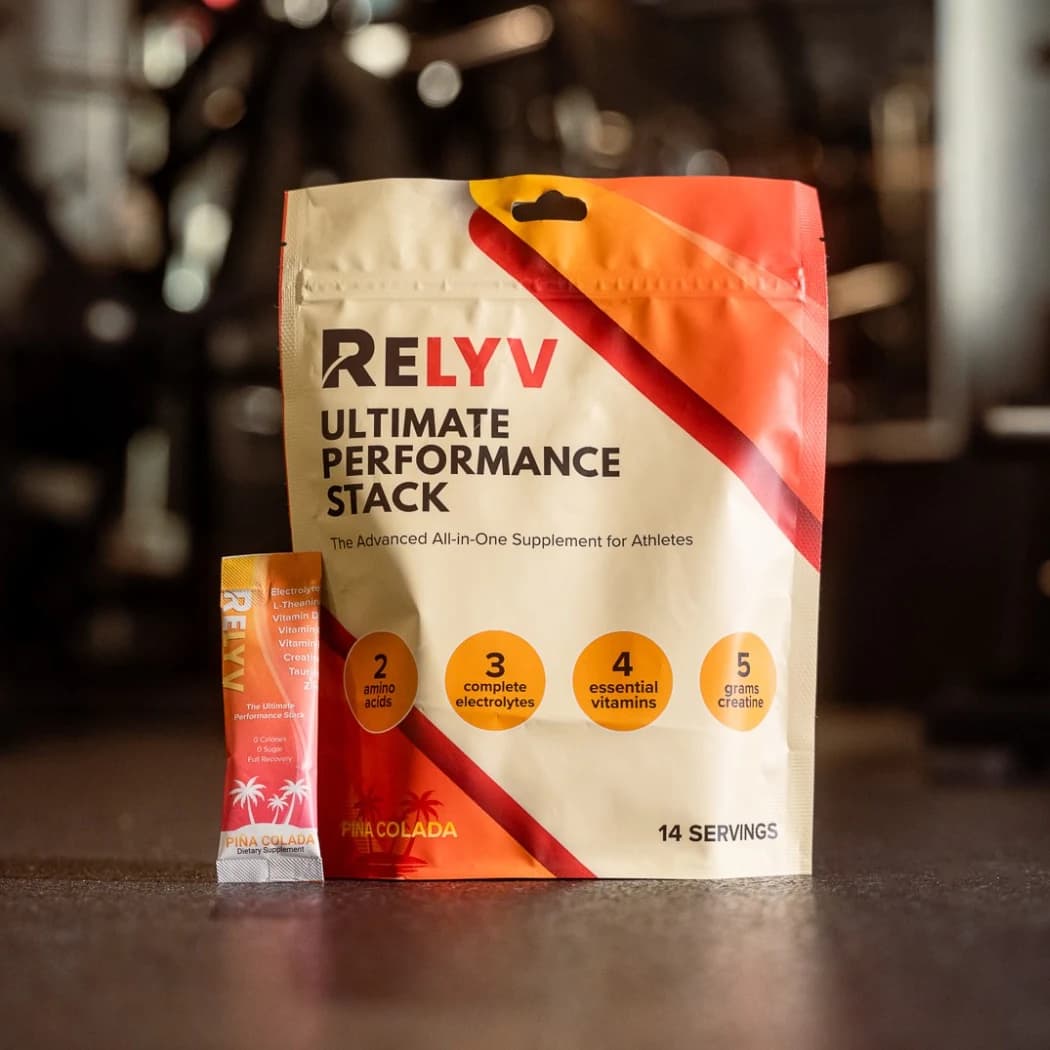 Relyv Ultimate Performance Stack pouch with a Piña Colada stick on a gym floor
